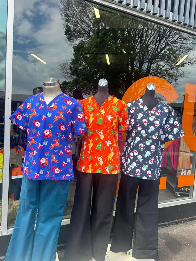 Printed scrub tops on mannequins in the Custom Workwear shop window