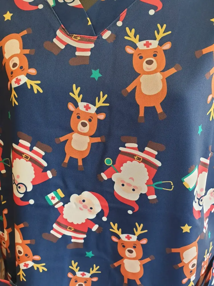Close-up of a Christmas print scrub top available at Custom Workwear