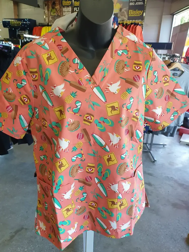 Pink patterned scrub top on display at Custom Workwear
