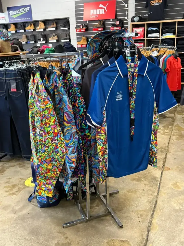 Colourful patterned workwear shirts and polos on racks at Custom Workwear
