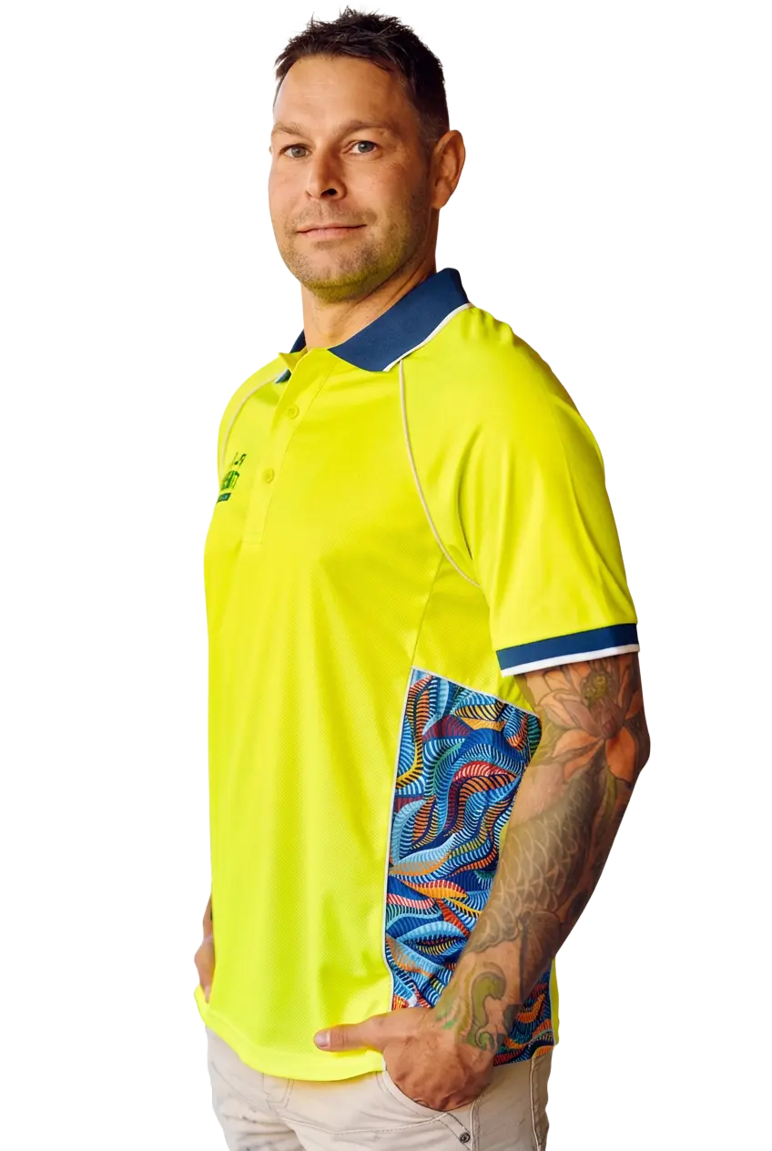Model wearing a yellow hi-vis work polo with patterned side panels