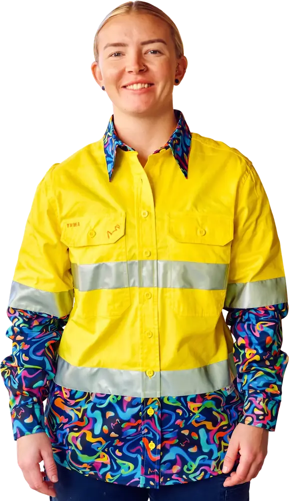 Woman wearing a yellow hi-vis work shirt with a navy patterned hem