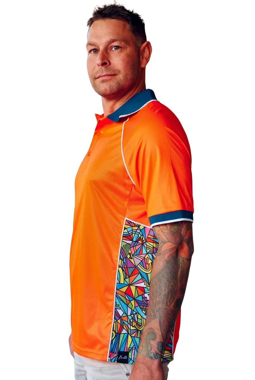 Model wearing an orange work polo with a navy collar and patterned side panels